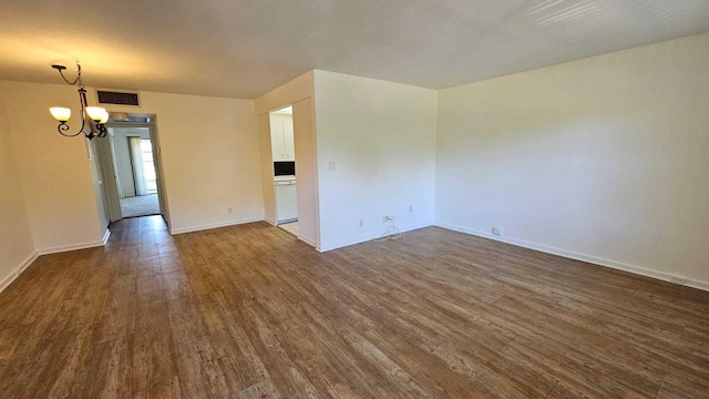 2905 Victoria Pl Unit D3, Coconut Creek, FL 33066 - spare room featuring dark wood finished floors and a chandelier