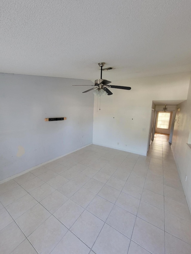 1355 Denlow Ln, Royal Palm Beach, FL 33411 - spare room featuring a textured ceiling, light tile patterned floors, and ceiling fan