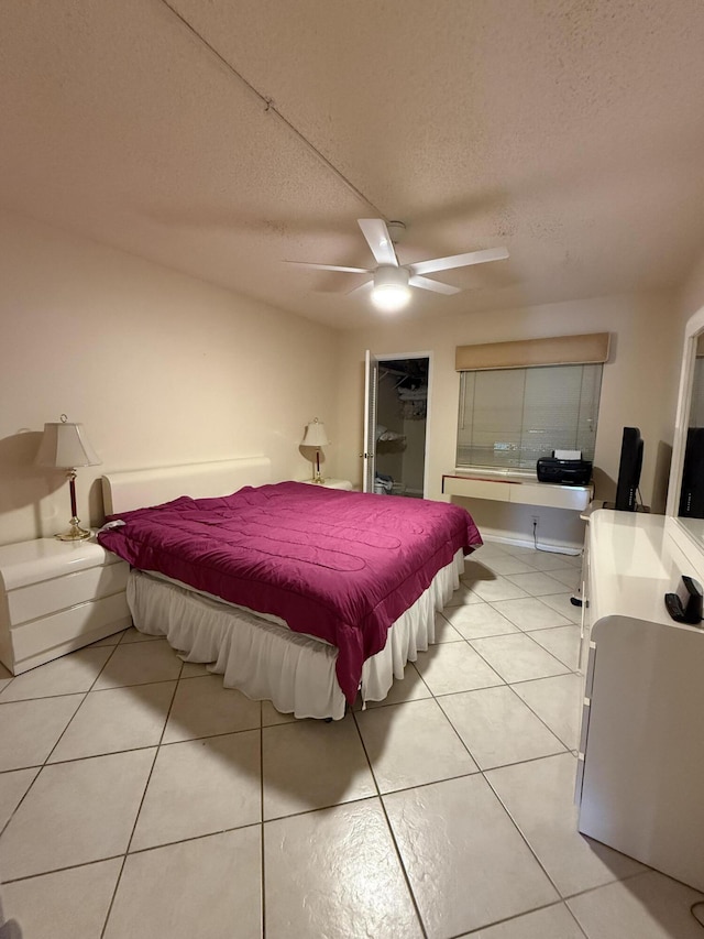 1046 Wolverton C, Boca Raton, FL 33434 - bedroom featuring light tile patterned floors, a textured ceiling, and a ceiling fan