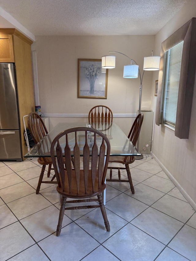 1046 Wolverton C, Boca Raton, FL 33434 - dining area with a textured ceiling and light tile patterned flooring