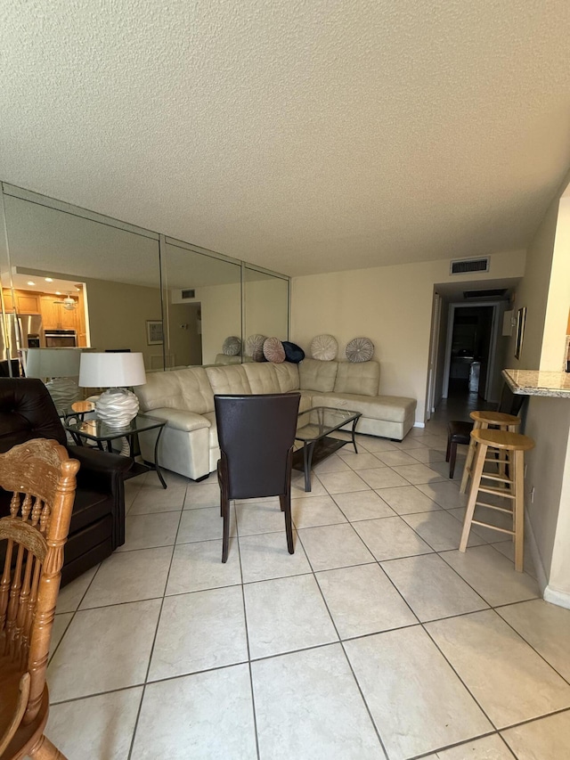 1046 Wolverton C, Boca Raton, FL 33434 - living room with a textured ceiling and light tile patterned flooring