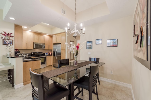 701 S Olive Ave Unit 714, West Palm Beach, FL 33401 - dining space with a tray ceiling, a chandelier, light tile patterned floors, and recessed lighting