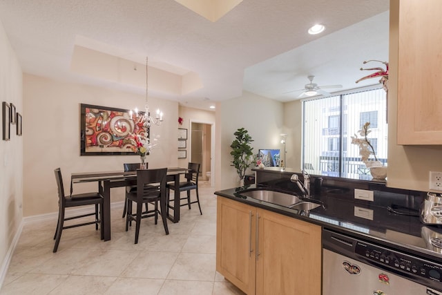 701 S Olive Ave Unit 714, West Palm Beach, FL 33401 - kitchen with stainless steel dishwasher, light brown cabinetry, dark countertops, ceiling fan, and hanging light fixtures