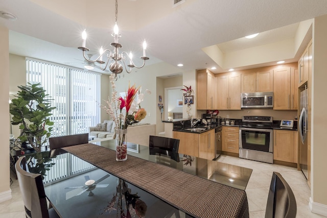 701 S Olive Ave Unit 714, West Palm Beach, FL 33401 - kitchen with stainless steel appliances, light brown cabinetry, dark countertops, a chandelier, and recessed lighting