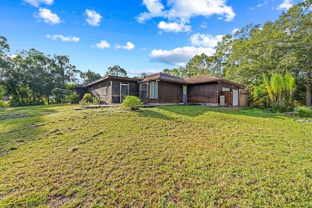 12401 174th Pl N, Jupiter, FL 33478 - rear view of house with a sunroom and a yard