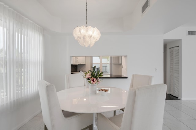 221 NE Plantation Rd Unit 303, Stuart, FL 34996 - dining area featuring a chandelier and light tile patterned floors