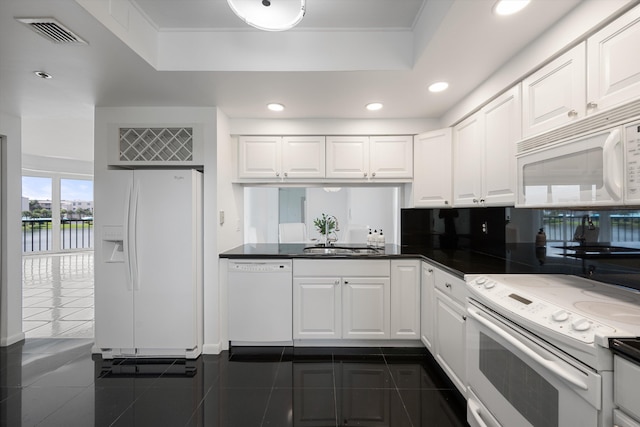221 NE Plantation Rd Unit 303, Stuart, FL 34996 - kitchen featuring white appliances, a raised ceiling, recessed lighting, white cabinets, and dark countertops
