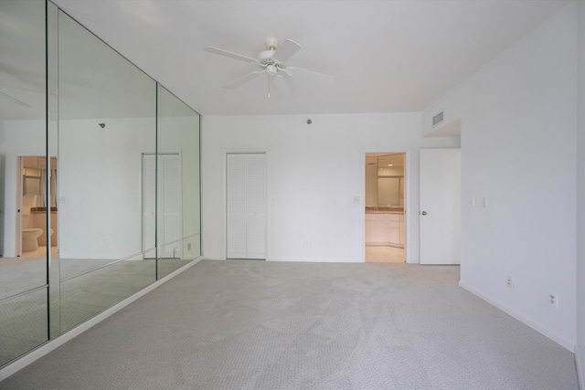 221 NE Plantation Rd Unit 303, Stuart, FL 34996 - unfurnished bedroom with carpet, ensuite bath, multiple closets, and a ceiling fan