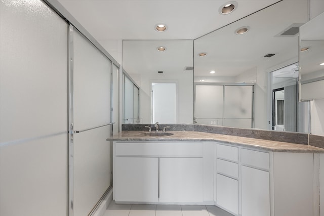 221 NE Plantation Rd Unit 303, Stuart, FL 34996 - bathroom featuring recessed lighting, a shower stall, double vanity, and tile patterned flooring