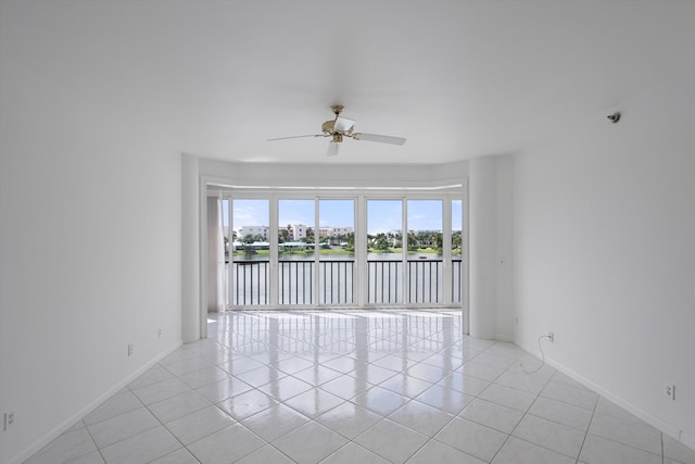 221 NE Plantation Rd Unit 303, Stuart, FL 34996 - spare room with a ceiling fan, a water view, and light tile patterned flooring