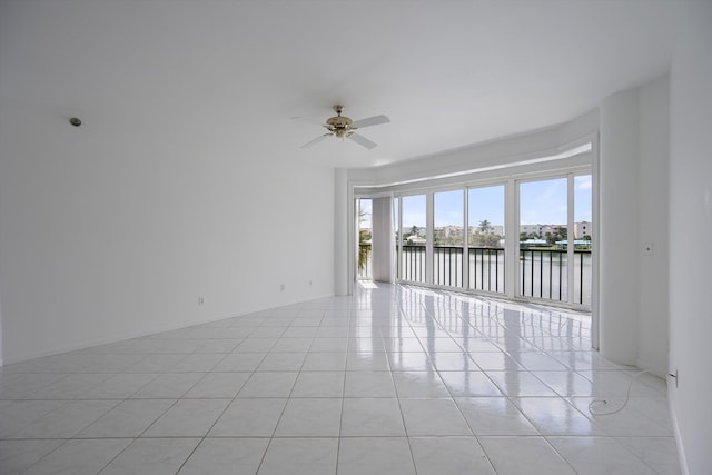 221 NE Plantation Rd Unit 303, Stuart, FL 34996 - spare room featuring a water view, ceiling fan, and light tile patterned floors
