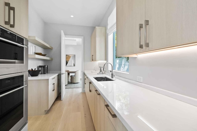 1280 S Ocean Blvd Unit Share A, Delray Beach, FL 33483 - kitchen featuring modern cabinets, light brown cabinetry, light wood-style flooring, stainless steel double oven, and light countertops
