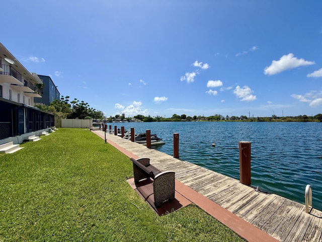 1100 Crystal Lake Dr Unit 107, Deerfield Beach, FL 33064 - dock area with a water view and a yard