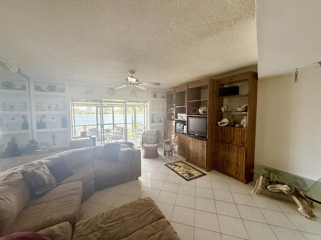1100 Crystal Lake Dr Unit 107, Deerfield Beach, FL 33064 - living room featuring a textured ceiling, a ceiling fan, and light tile patterned flooring