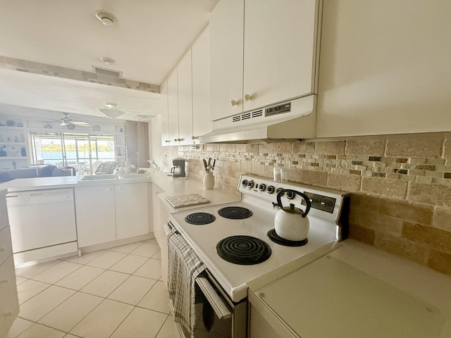 1100 Crystal Lake Dr Unit 107, Deerfield Beach, FL 33064 - kitchen with white appliances, under cabinet range hood, white cabinets, light countertops, and tasteful backsplash