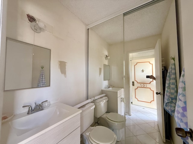 1100 Crystal Lake Dr Unit 107, Deerfield Beach, FL 33064 - bathroom with a textured ceiling, vanity, and tile patterned floors