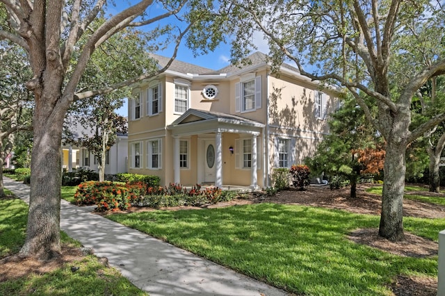 240 Honeysuckle Dr, Jupiter, FL 33458 - view of front facade with stucco siding and a front lawn