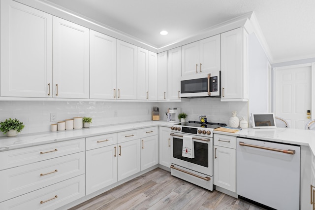 240 Honeysuckle Dr, Jupiter, FL 33458 - kitchen featuring white appliances, decorative backsplash, white cabinets, light wood-style floors, and recessed lighting