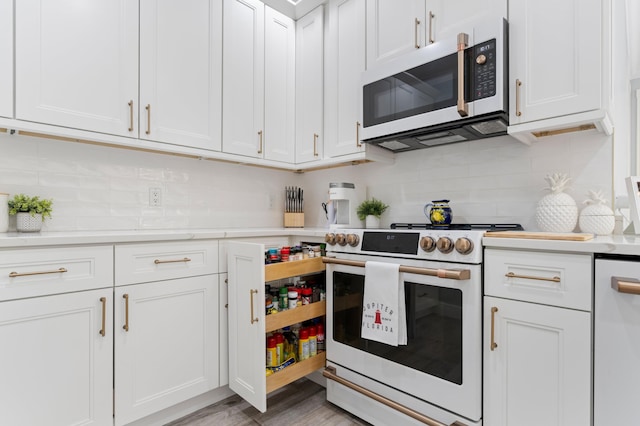 240 Honeysuckle Dr, Jupiter, FL 33458 - kitchen with white appliances, light countertops, white cabinetry, and tasteful backsplash