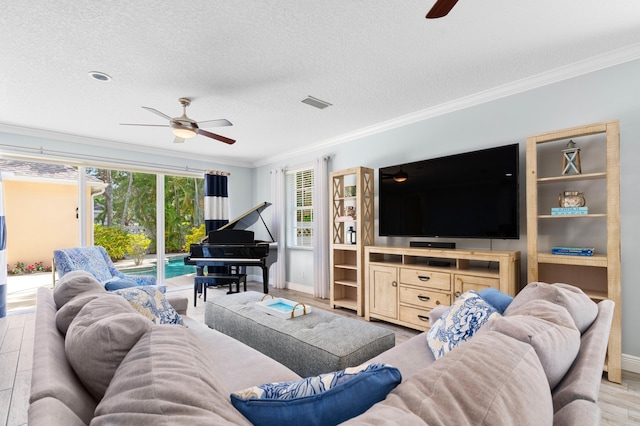 240 Honeysuckle Dr, Jupiter, FL 33458 - living area featuring a ceiling fan, ornamental molding, a textured ceiling, and light wood finished floors