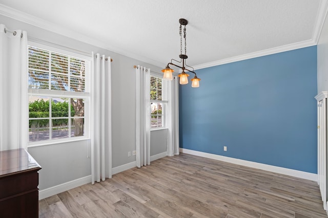 240 Honeysuckle Dr, Jupiter, FL 33458 - unfurnished dining area featuring healthy amount of natural light, wood finished floors, ornamental molding, and a textured ceiling