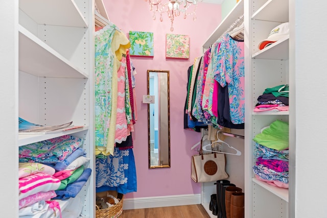 240 Honeysuckle Dr, Jupiter, FL 33458 - walk in closet with wood finished floors and a chandelier