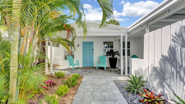 218 NE 10th St, Delray Beach, FL 33444 - view of exterior entry with covered porch and stucco siding