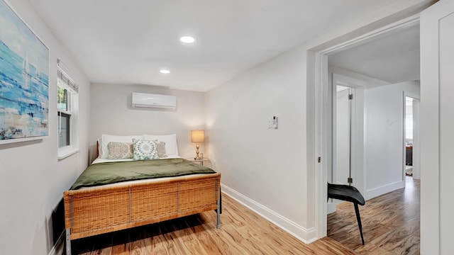 218 NE 10th St, Delray Beach, FL 33444 - bedroom featuring an AC wall unit, wood finished floors, and recessed lighting