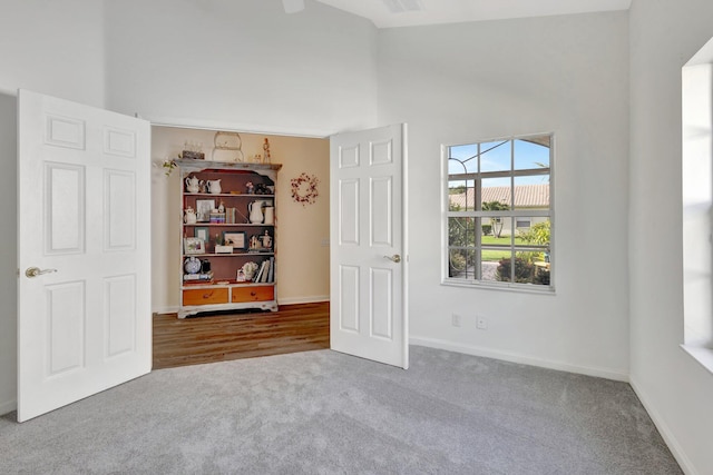 352 NW Granville St, Port Saint Lucie, FL 34986 - unfurnished room with carpet floors and high vaulted ceiling
