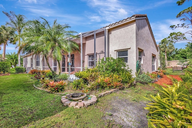 352 NW Granville St, Port Saint Lucie, FL 34986 - back of house with a lawn and stucco siding