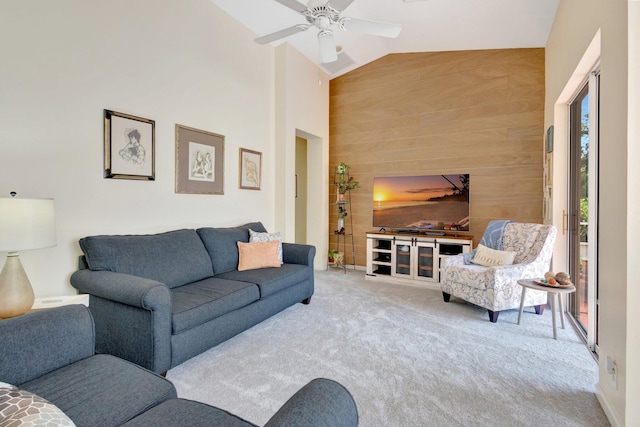 352 NW Granville St, Port Saint Lucie, FL 34986 - carpeted living room with an accent wall, a ceiling fan, lofted ceiling, and wood walls