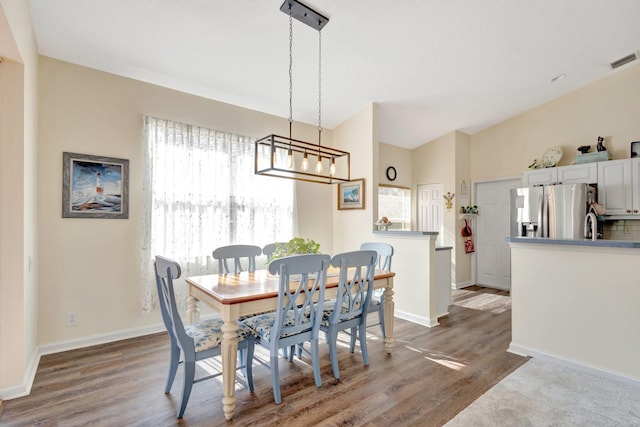 352 NW Granville St, Port Saint Lucie, FL 34986 - dining space featuring wood finished floors and a chandelier