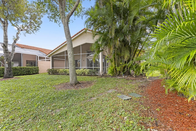 7117 Treviso Ln, Boynton Beach, FL 33472 - view of side of property featuring a sunroom, stucco siding, a tile roof, and a yard