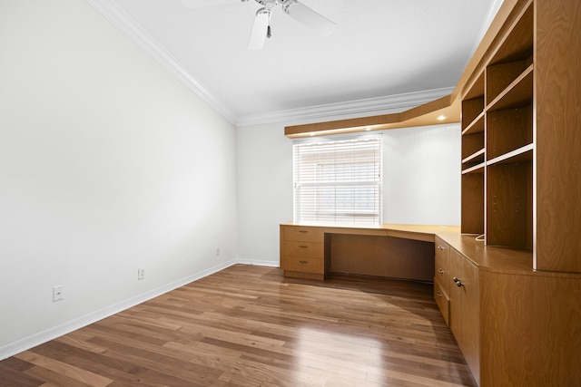 7117 Treviso Ln, Boynton Beach, FL 33472 - unfurnished office featuring crown molding, built in desk, ceiling fan, and wood finished floors