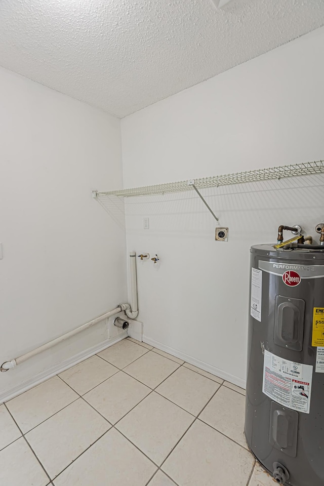706 Azalea Ave, Fort Pierce, FL 34982 - washroom featuring water heater, hookup for an electric dryer, light tile patterned flooring, and a textured ceiling