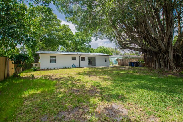 706 Azalea Ave, Fort Pierce, FL 34982 - rear view of house featuring a fenced backyard and stucco siding