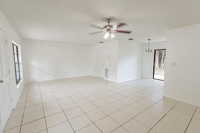 706 Azalea Ave, Fort Pierce, FL 34982 - spare room featuring ceiling fan, a chandelier, light tile patterned floors, and a textured ceiling