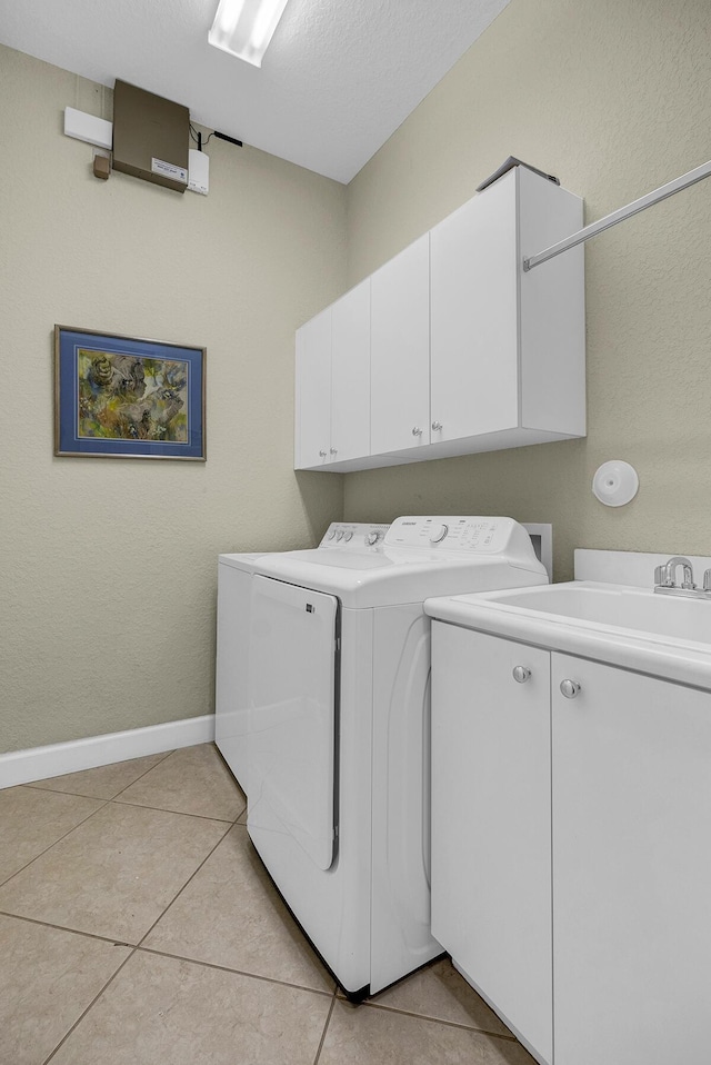 6496 San Michel Way, Delray Beach, FL 33484 - washroom featuring cabinet space, washer and dryer, and light tile patterned floors