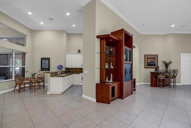 6496 San Michel Way, Delray Beach, FL 33484 - kitchen featuring light tile patterned floors, dark countertops, crown molding, recessed lighting, and white cabinets