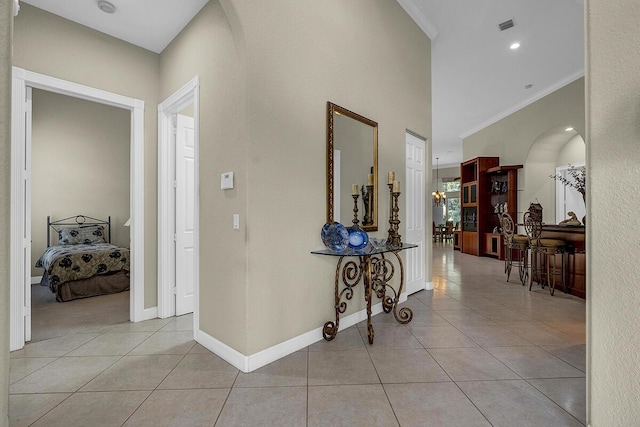 6496 San Michel Way, Delray Beach, FL 33484 - hall featuring light tile patterned flooring, crown molding, and arched walkways