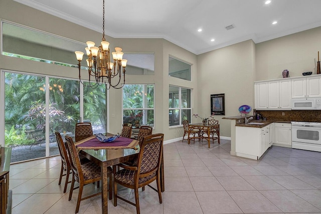 6496 San Michel Way, Delray Beach, FL 33484 - dining room featuring crown molding, healthy amount of natural light, light tile patterned flooring, a chandelier, and recessed lighting