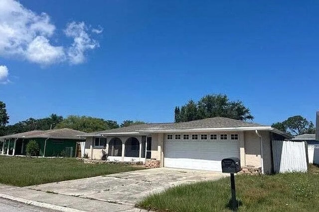 7619 Summertree Ln, New Port Richey, FL 34653 - single story home with a garage, a front yard, and concrete driveway