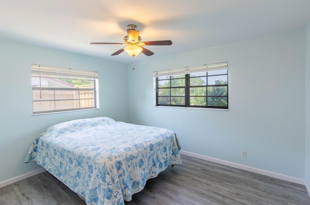 12069 Easterly Ave, Palm Beach Gardens, FL 33410 - bedroom with multiple windows, wood finished floors, and ceiling fan