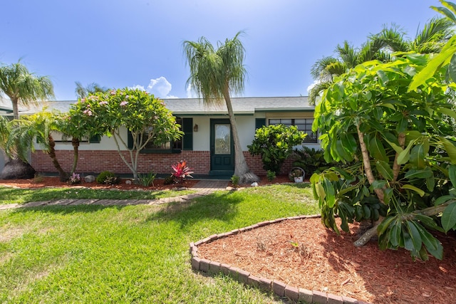 12069 Easterly Ave, Palm Beach Gardens, FL 33410 - ranch-style house featuring brick siding and a front yard