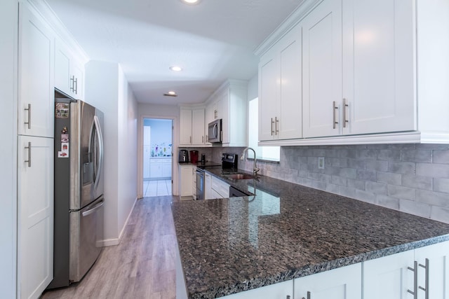 12069 Easterly Ave, Palm Beach Gardens, FL 33410 - kitchen featuring stainless steel appliances, white cabinets, tasteful backsplash, light wood-style flooring, and recessed lighting