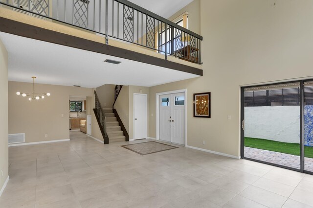 368 SW 29th Ave, Delray Beach, FL 33445 - tiled foyer entrance featuring healthy amount of natural light, a textured ceiling, and stairs