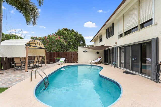 368 SW 29th Ave, Delray Beach, FL 33445 - kitchen featuring appliances with stainless steel finishes, tasteful backsplash, stainless steel countertops, light tile patterned floors, and a center island