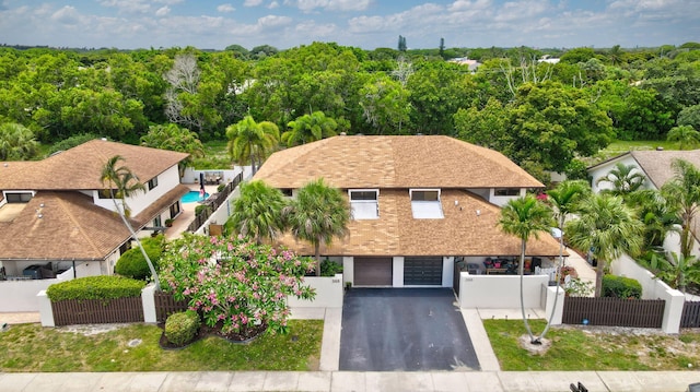 368 SW 29th Ave, Delray Beach, FL 33445 - view of front facade with a fenced front yard, an attached garage, and asphalt driveway