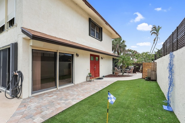 368 SW 29th Ave, Delray Beach, FL 33445 - rear view of house with stucco siding, a fenced backyard, and a patio