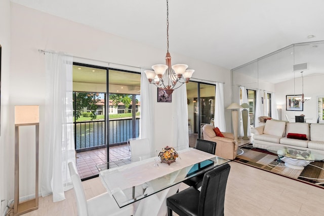 10263 N Circle Lake Dr Unit 201, Boynton Beach, FL 33437 - dining room with a chandelier, a water view, and lofted ceiling